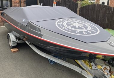 Canvasman Bespoke Black Over-Screen Speedboat Cockpit Tonneau with signage and logo