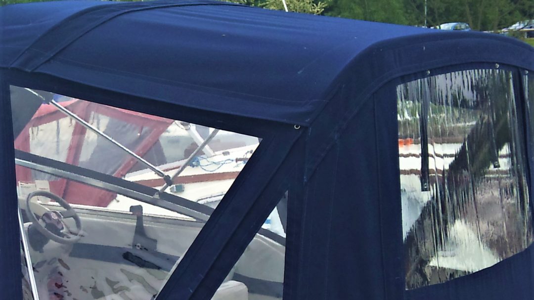 Navy Blue Motor Cruiser with campa back with a flap, zip and sleeve to create a split roof